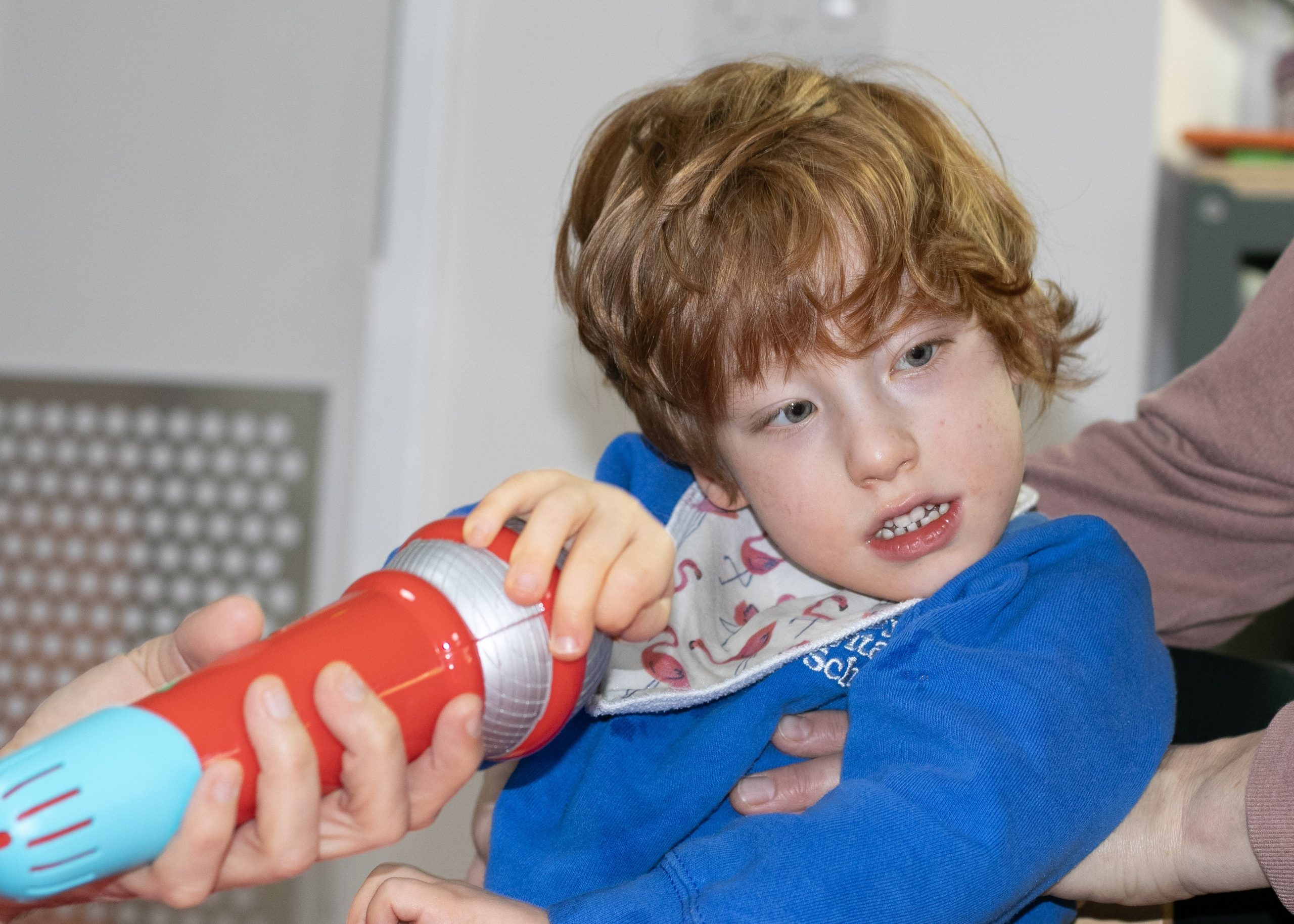 Jothi holding a microphone in a conductive education session.