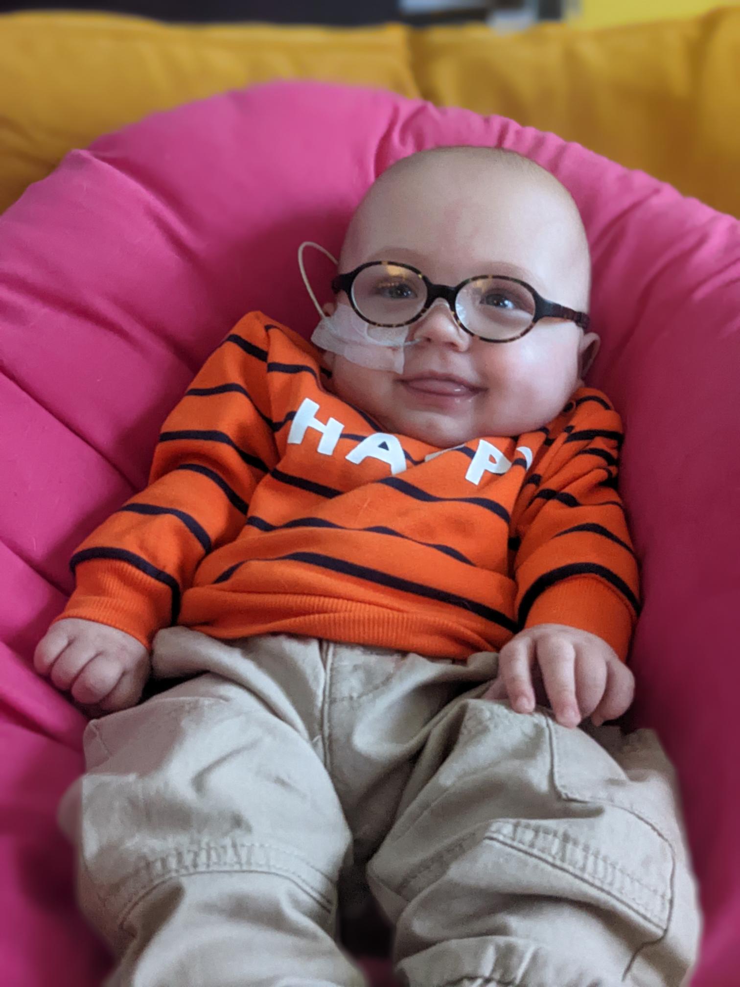 Otis as a baby with glasses and an NG tube in his nose.