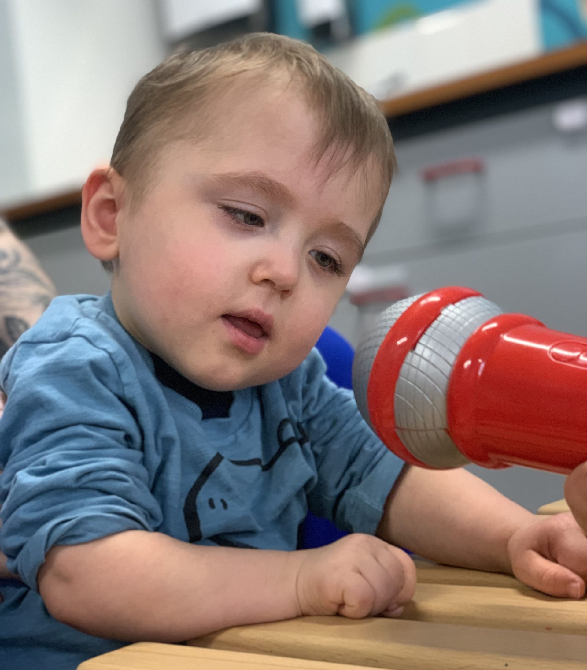 Otis using a microphone in a conductive education session.