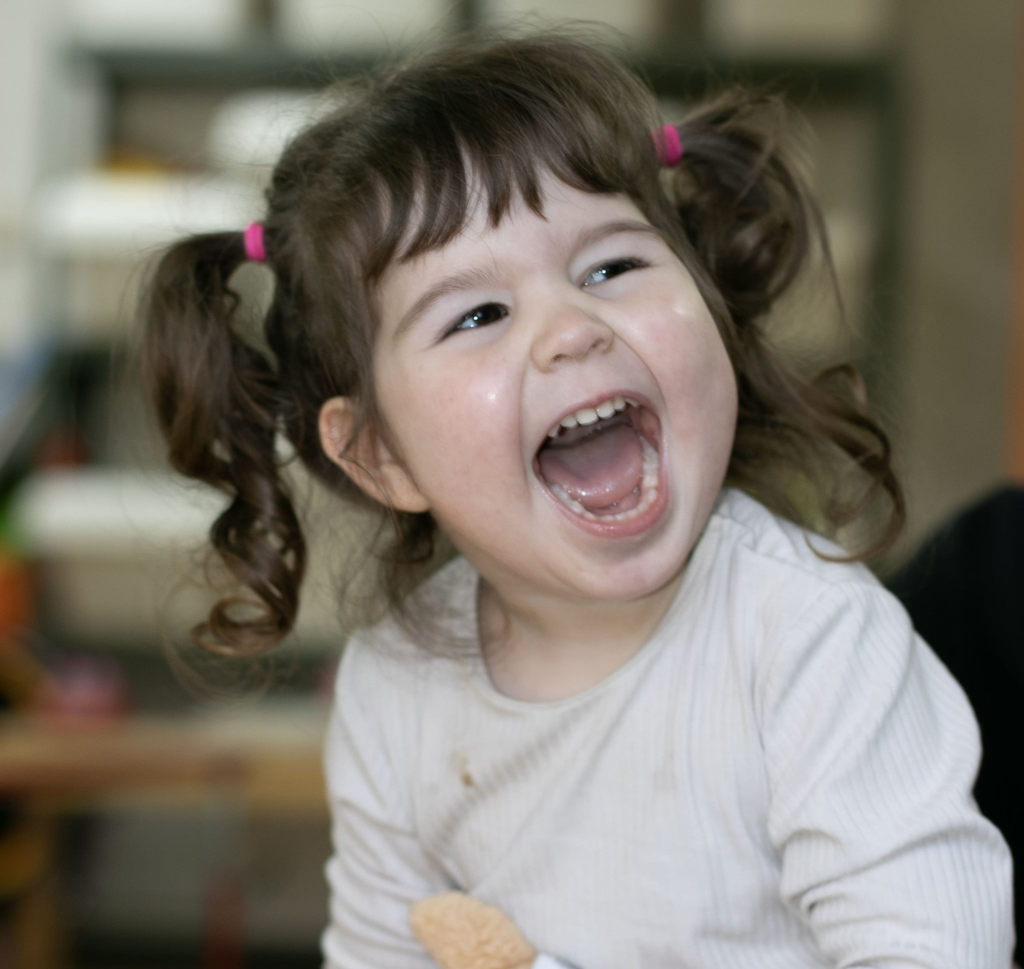 A young girl with cerebral palsy smiling.