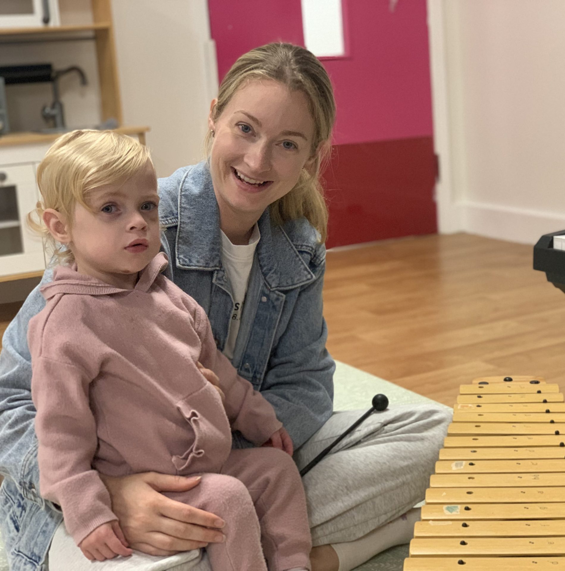 Elsie and her mum in a music therapy session, playing the xylophone.