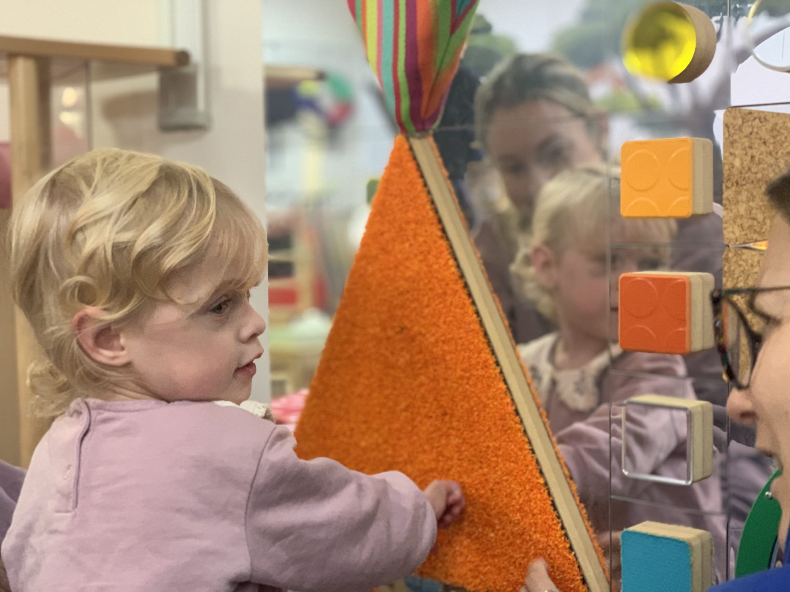 A young girl playing with a sensory game.